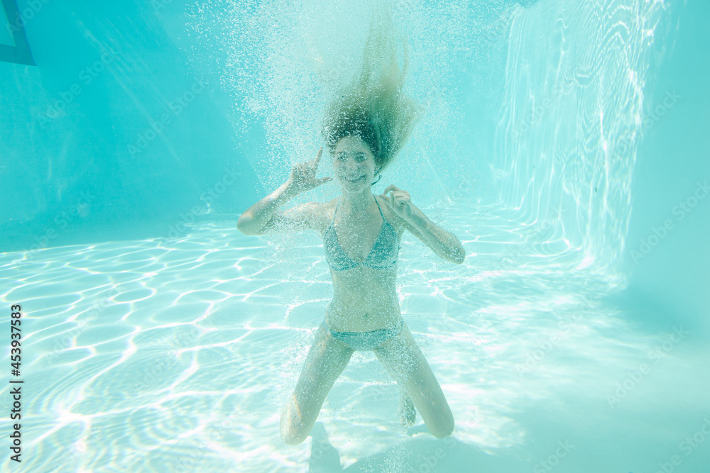 Woman posing underwater in pool