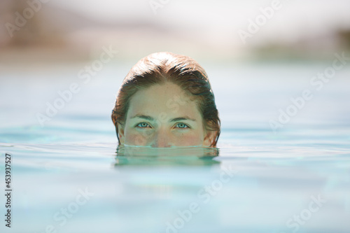 Close up of woman relaxing in swimming pool