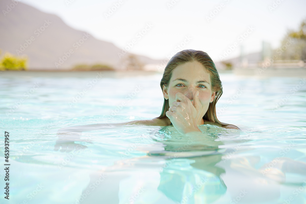 Close up of woman relaxing in swimming pool