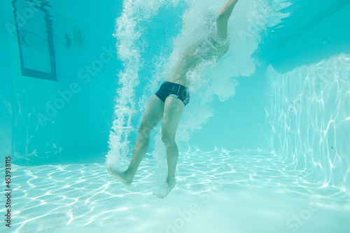 Man posing underwater in swimming pool © KOTO