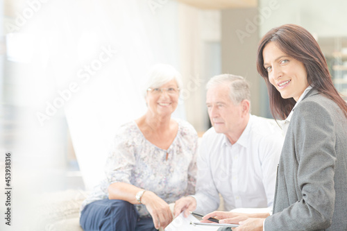 Financial advisor smiling with couple on sofa