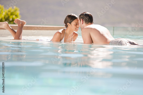 Couple relaxing together in swimming pool © KOTO