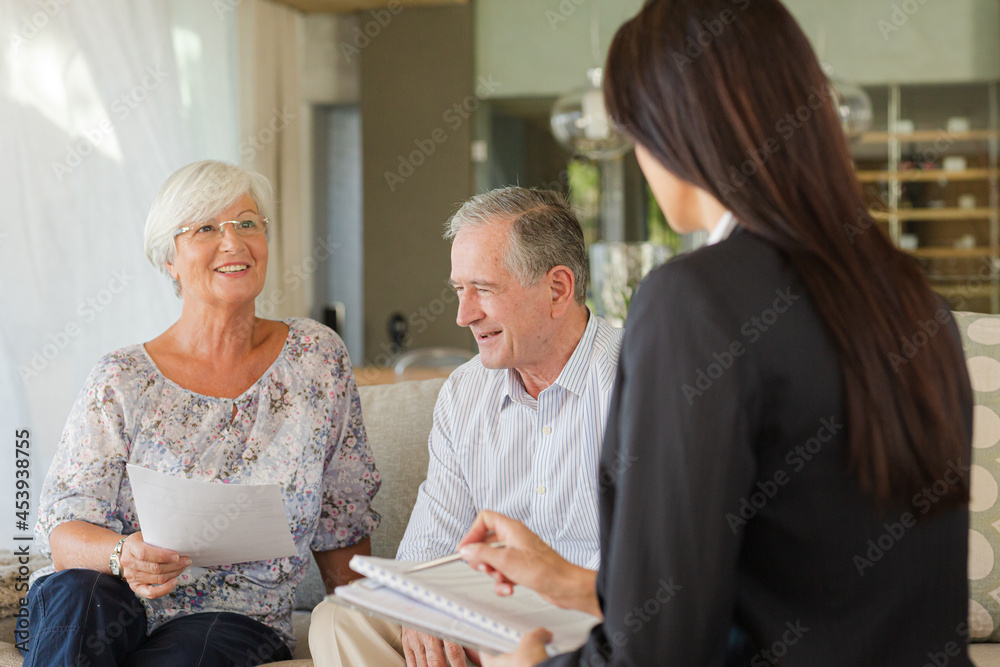 Financial advisor talking to couple on sofa