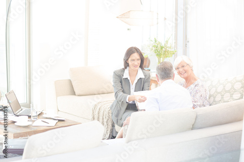 Financial advisor talking to couple on sofa