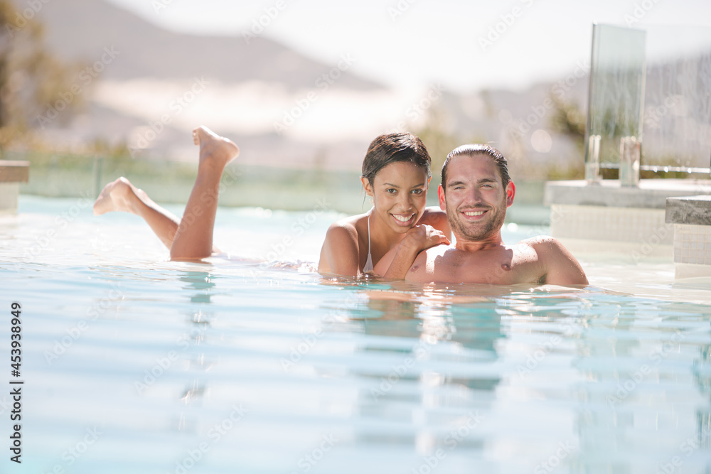 Couple relaxing in swimming pool Couple relaxing in swimming pool