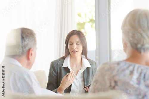 Financial advisor with couple on sofa