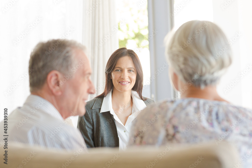 Financial advisor with couple on sofa Financial advisor with couple on sofa