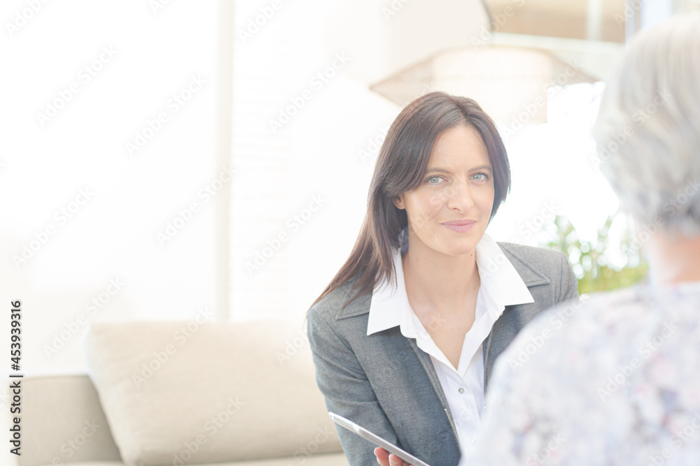 Financial advisor using tablet computer with clients Financial advisor using tablet computer with clients
