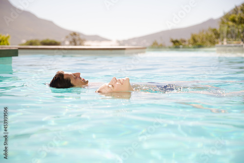 Couple floating in swimming pool