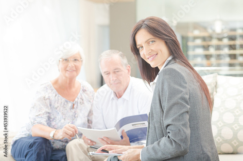 Financial advisor smiling with couple on sofa