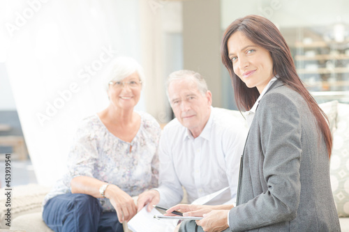 Financial advisor smiling with couple on sofa