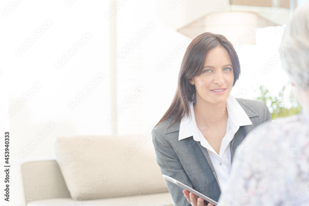 Financial advisor using tablet computer with clients Financial advisor using tablet computer with clients