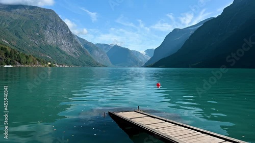Beautiful Lake Lovatnet in Norway with a jetty crossing the turquoise water. photo