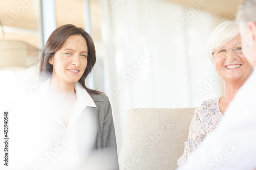 Financial advisor talking to couple on sofa