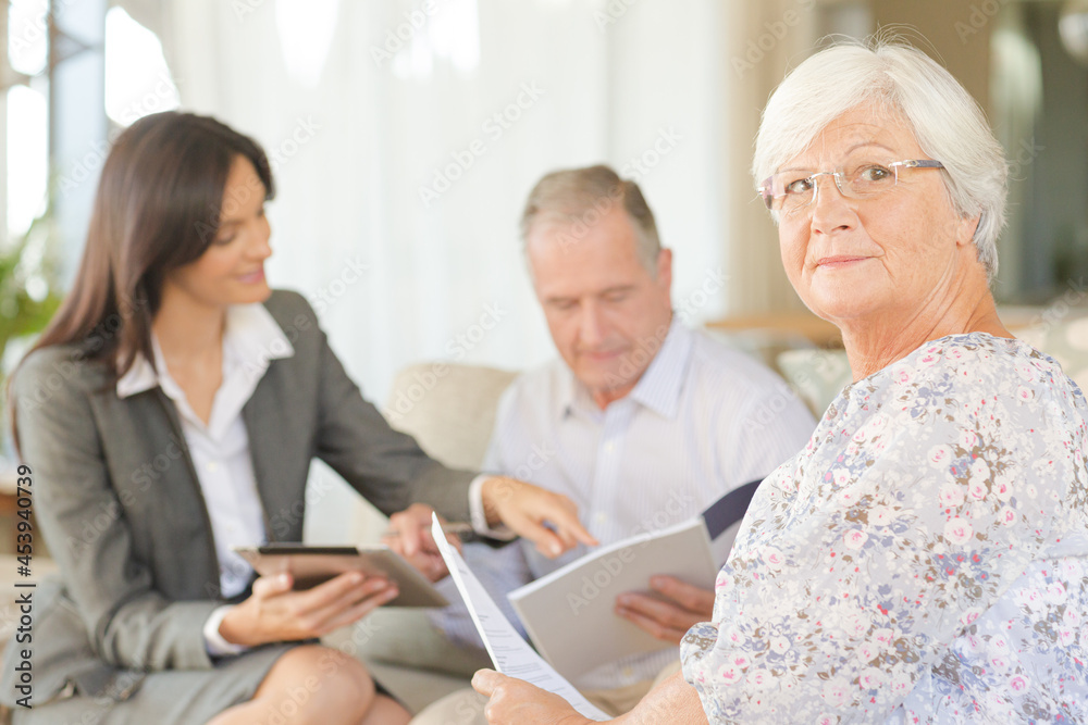 Financial advisor using tablet computer with clients Financial advisor using tablet computer with clients