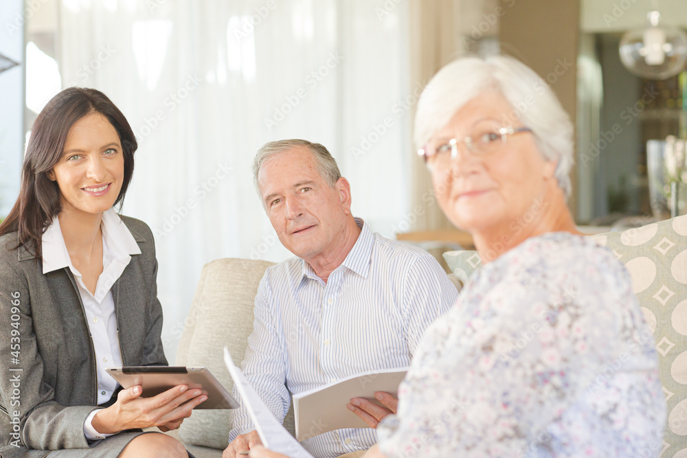 Financial advisor using tablet computer with clients Financial advisor using tablet computer with clients