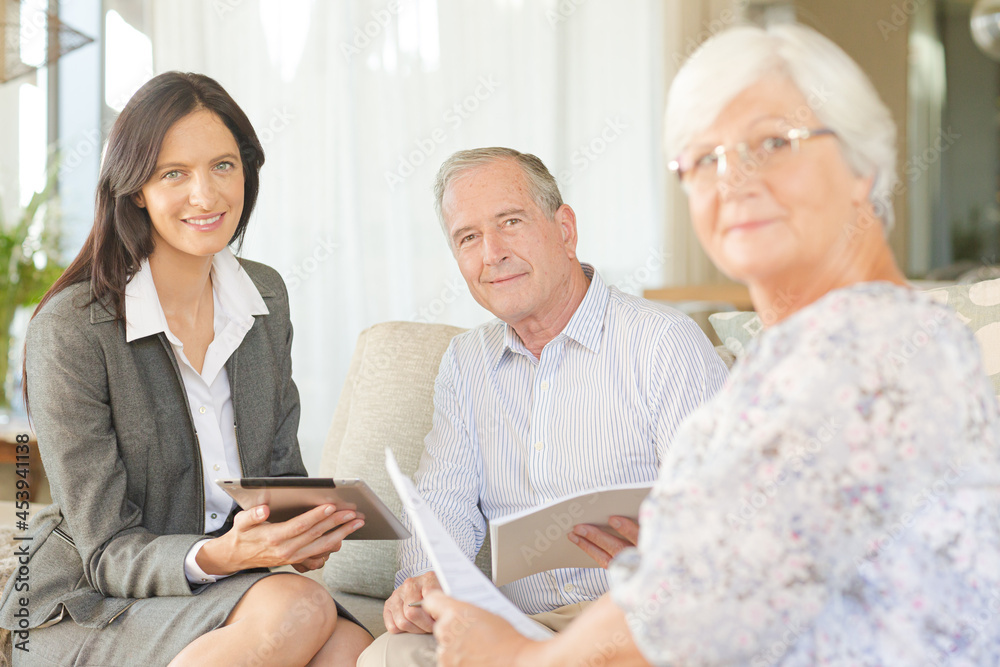Financial advisor using tablet computer with clients Financial advisor using tablet computer with clients