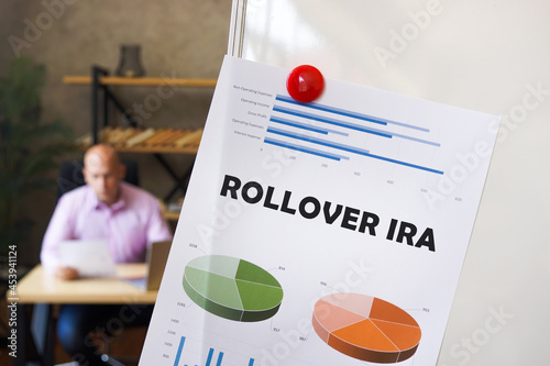Financial concept meaning ROLLOVER IRA with phrase on the chart sheet. Businessman working at work table photo