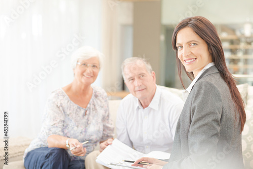 Financial advisor smiling with couple on sofa