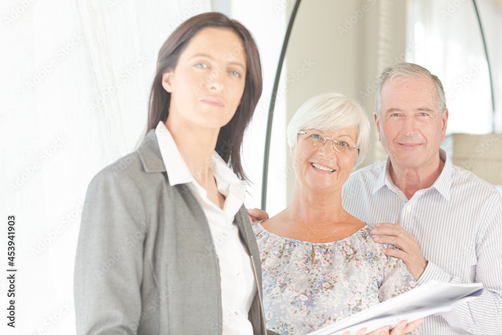 Financial advisor posing with clients Financial advisor posing with clients