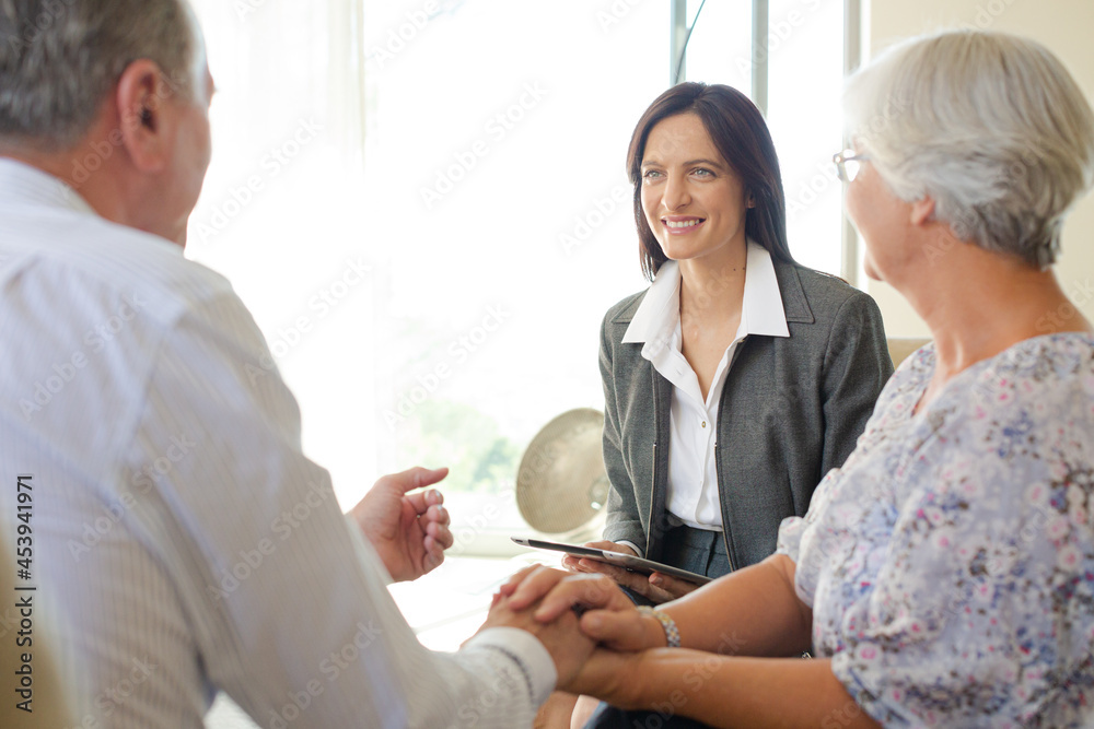 Fototapeta premium Financial advisor talking to couple on sofa