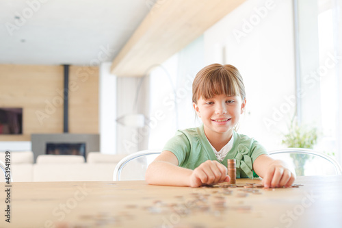 Girl stacking pennies on counter
