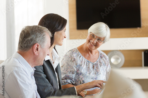 Financial advisor sitting on sofa with clients