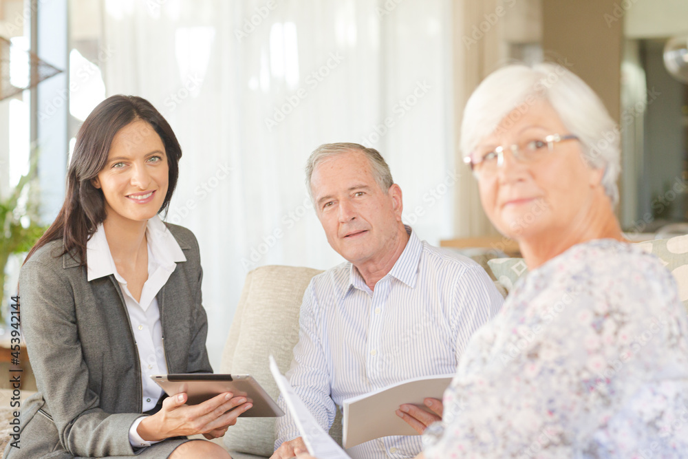 Financial advisor using tablet computer with clients Financial advisor using tablet computer with clients