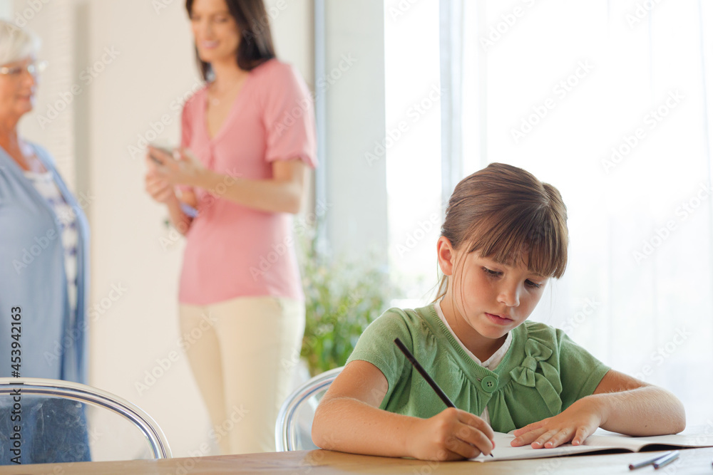 Girl doing homework at table Girl doing homework at table