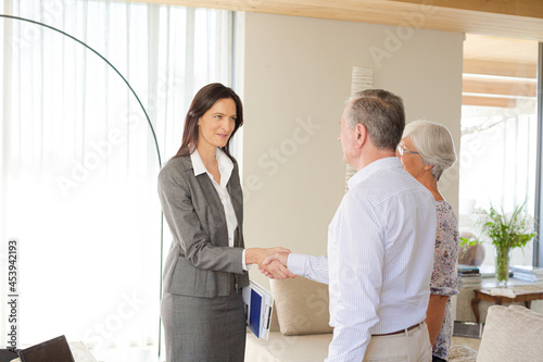 Financial advisor talking to couple indoors