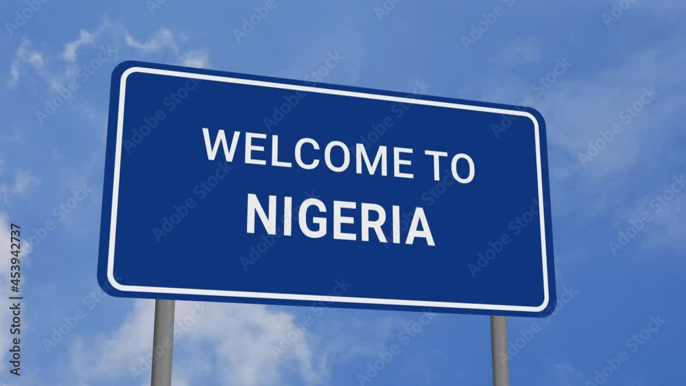 Welcome to Nigeria Road Sign on Clear Blue Sky with Rapid Moving Clouds Welcome to Nigeria Road Sign on Clear Blue Sky with Rapid Moving Clouds
