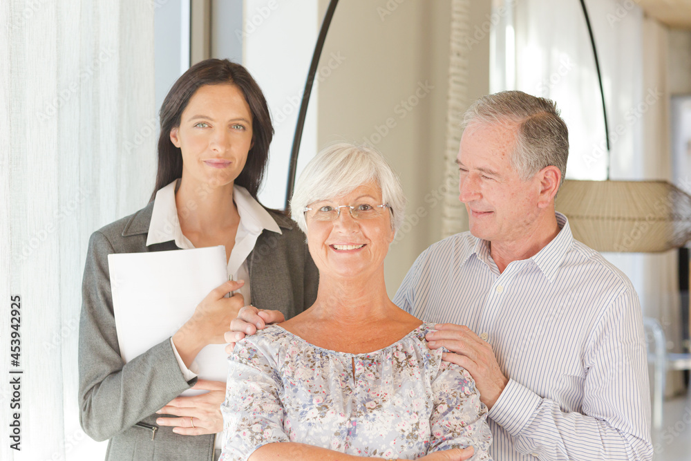 Financial advisor posing with clients Financial advisor posing with clients