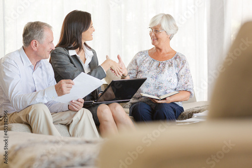 Financial advisor using tablet computer with clients