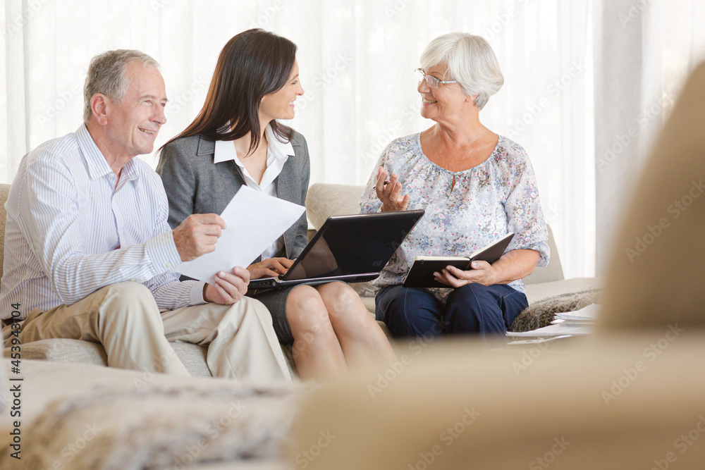 Financial advisor using tablet computer with clients Financial advisor using tablet computer with clients