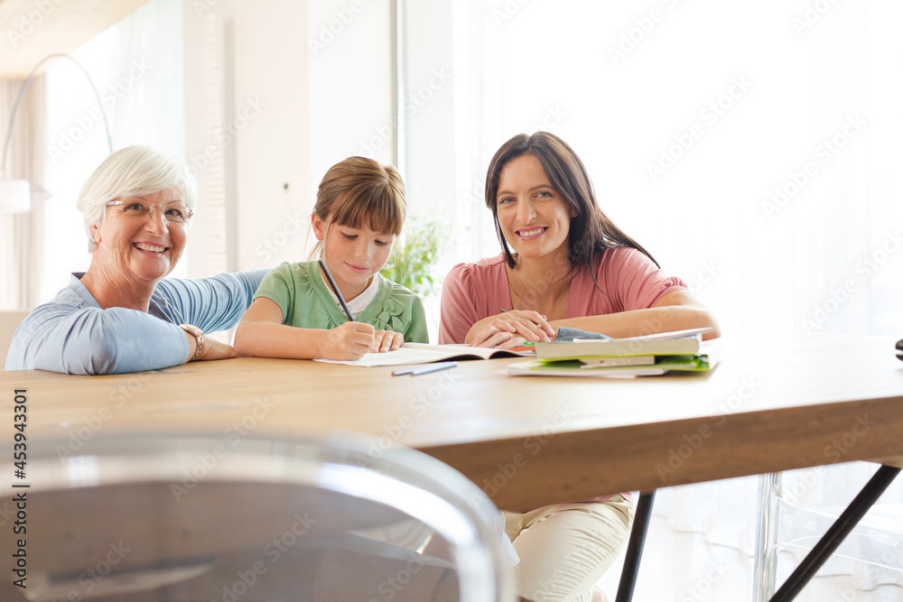 Mother and grandmother helping girl with homework Mother and grandmother helping girl with homework