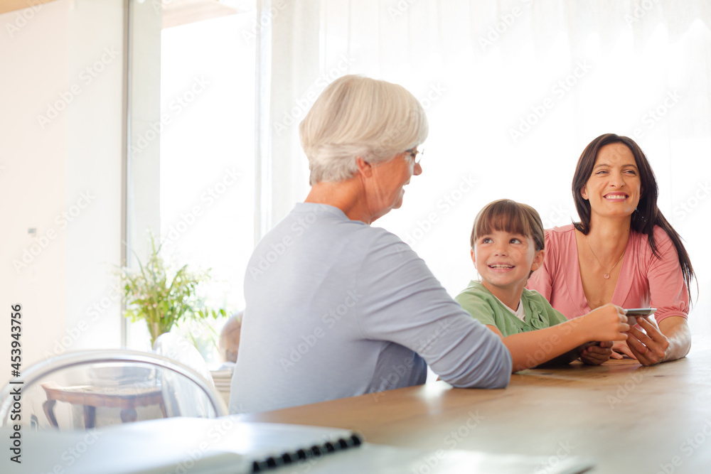 Three generations of women using tablet computer Three generations of women using tablet computer