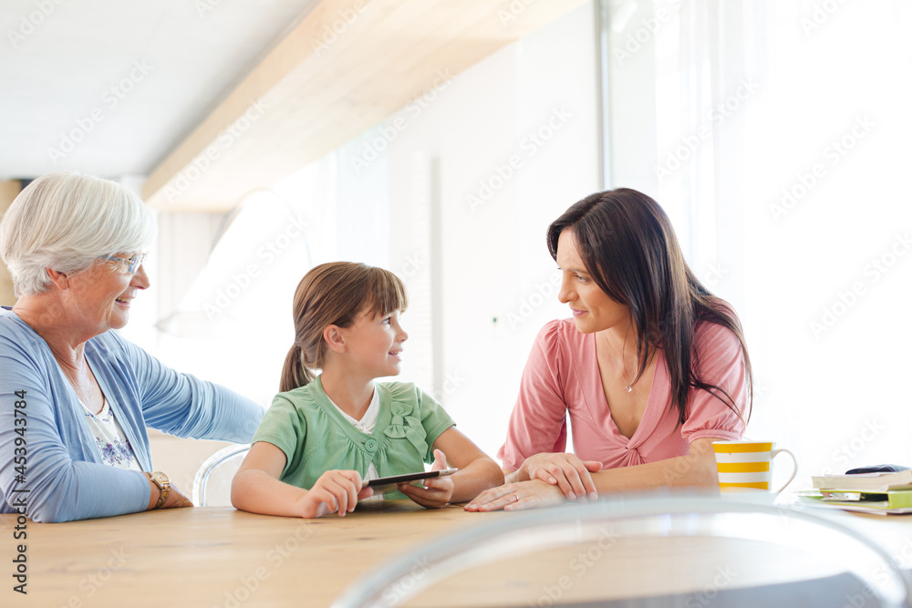 Three generations of women using tablet computer Three generations of women using tablet computer