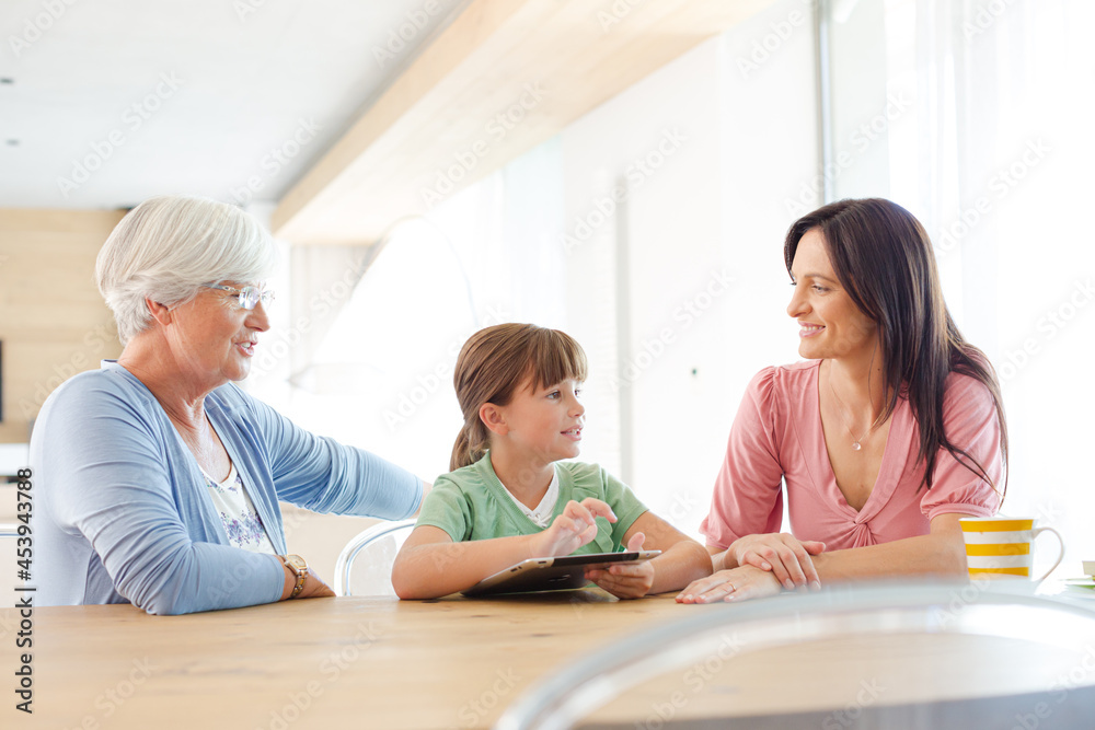 Three generations of women using tablet computer Three generations of women using tablet computer
