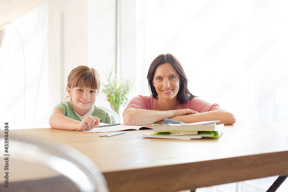 Mother helping daughter with homework Mother helping daughter with homework
