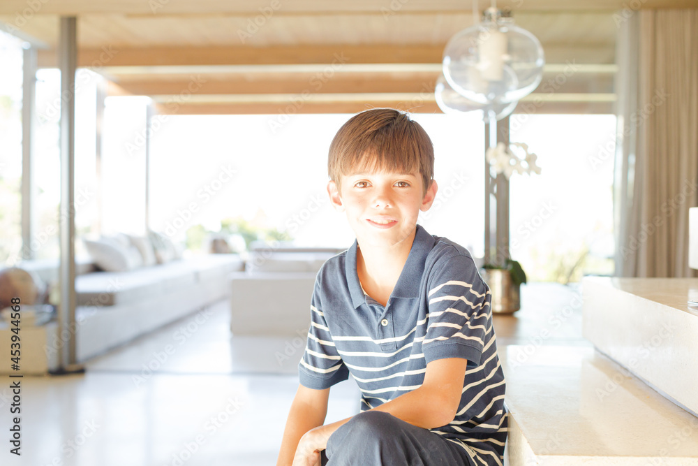 Boy posing in modern house, smiling Boy posing in modern house, smiling