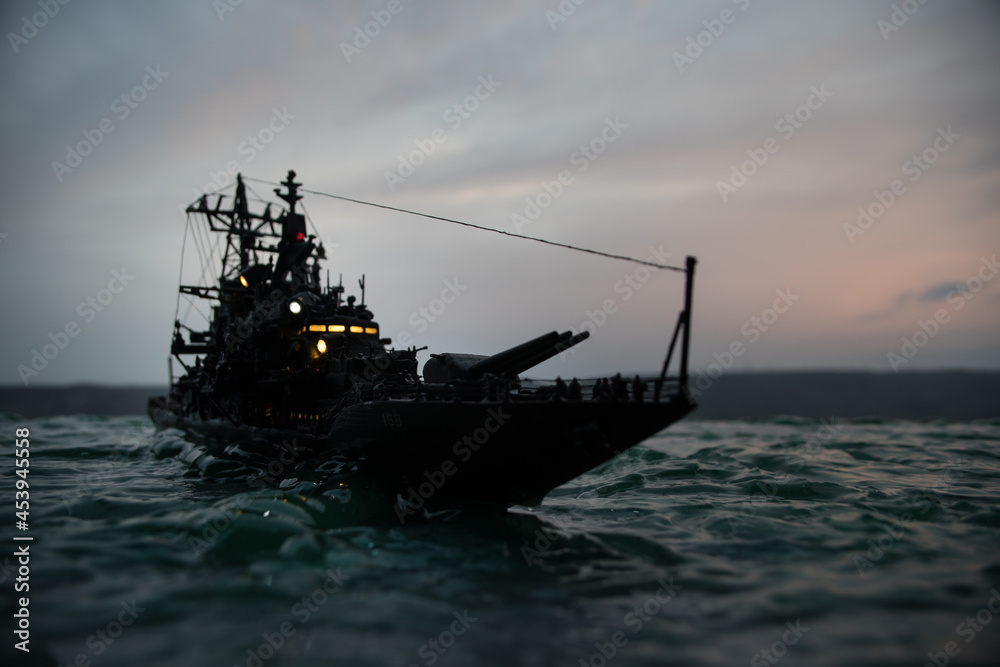 Silhouettes of a crowd standing at blurred military war ship on foggy background. Selective focus. Silhouettes of a crowd standing at blurred military war ship on foggy background. Selective focus.