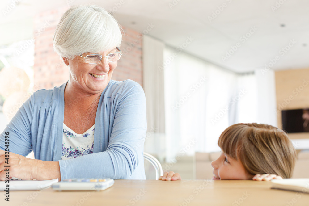 Older woman and granddaughter using calculator Older woman and granddaughter using calculator