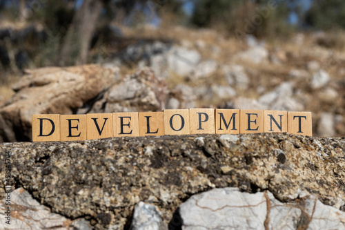 The word development was created from wooden cubes. Photographed on the wall. photo