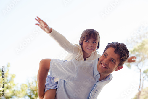 Father and daughter hugging outdoors