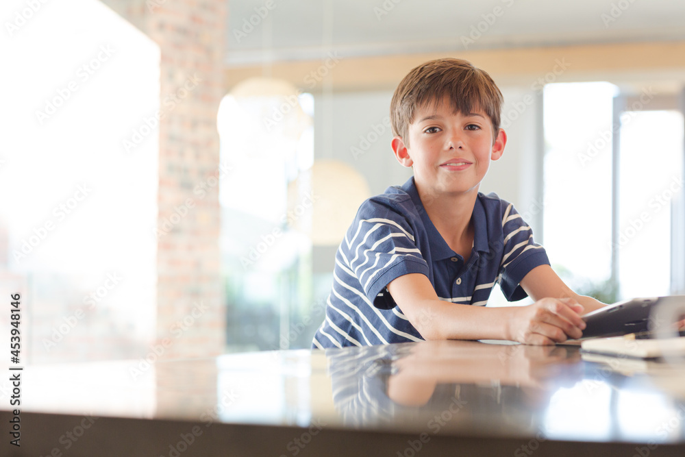 Boy posing with computer tablet in kitchen Boy posing with computer tablet in kitchen