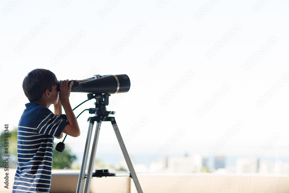 Boy using telescope outdoors Boy using telescope outdoors