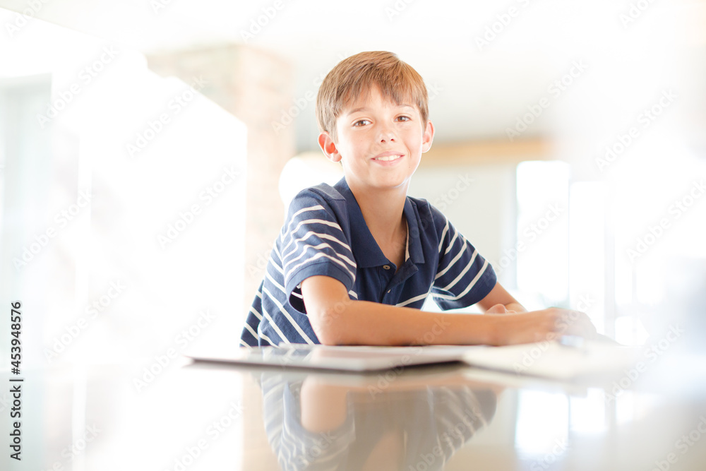 Boy using tablet computer in kitchen Boy using tablet computer in kitchen