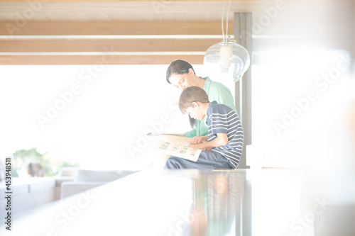 Mother and son posing in modern house