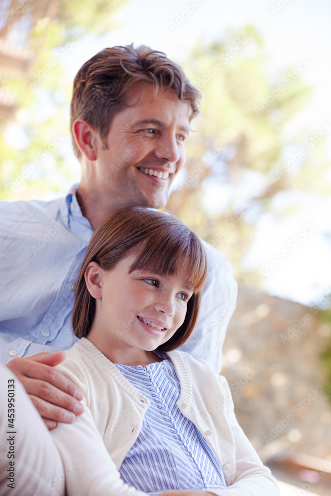 Father and daughter outdoors, smiling Father and daughter outdoors, smiling
