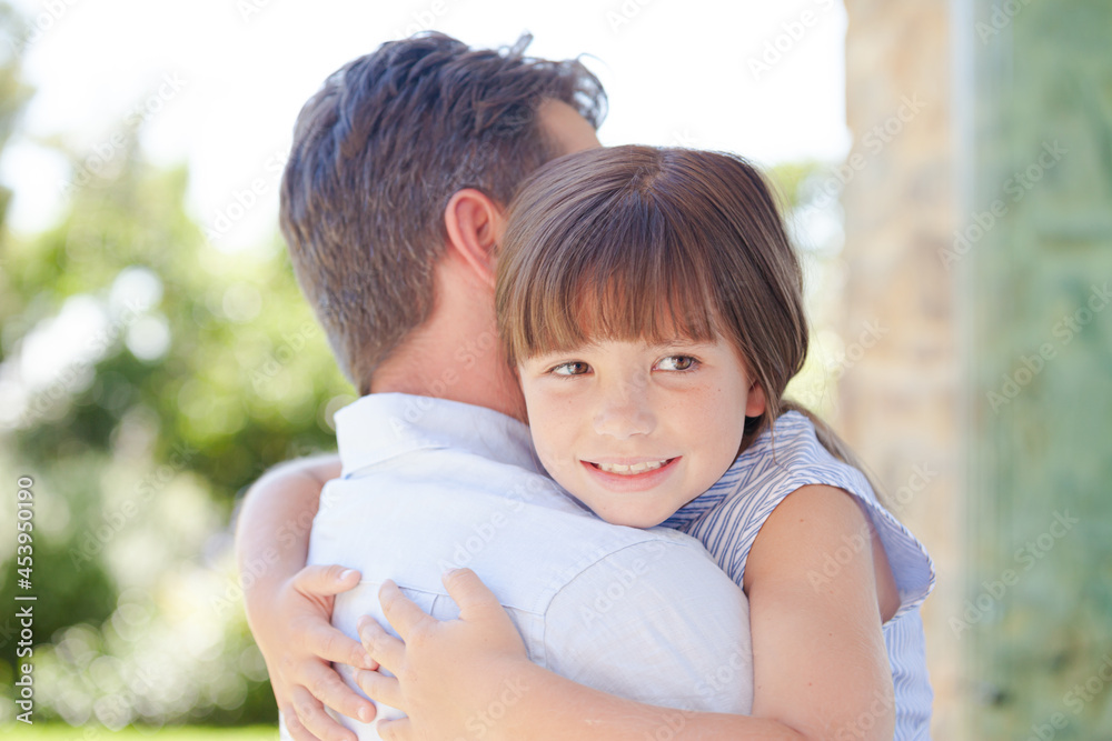 Father and daughter hugging outdoors Father and daughter hugging outdoors